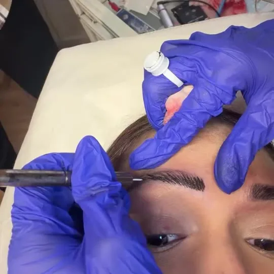 Pigment being applied to a mapped brow
